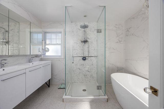 7203 Ingram St, Forest Hills, NY 11375 - bathroom featuring a marble finish shower, a freestanding tub, tile walls, and double vanity