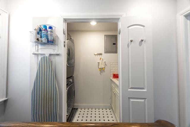 7203 Ingram St, Forest Hills, NY 11375 - laundry room featuring stacked washer and clothes dryer, electric panel, and baseboards