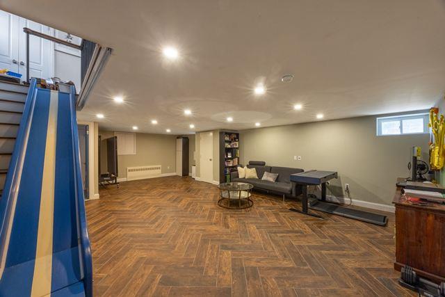 7203 Ingram St, Forest Hills, NY 11375 - living room with baseboards, recessed lighting, and stairs