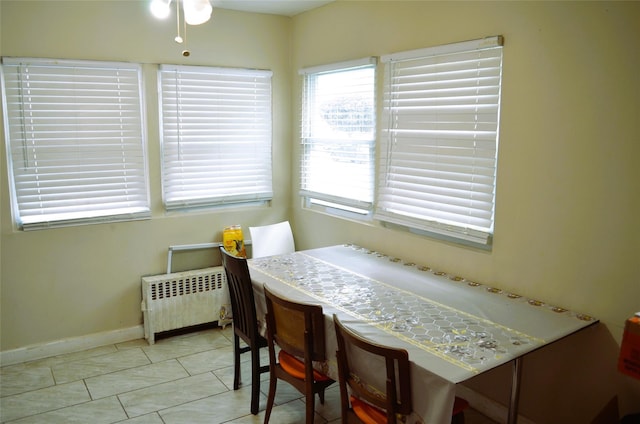 110 Powell Pl, Hempstead, NY 11550 - dining room with radiator, baseboards, tile patterned floors, and a ceiling fan