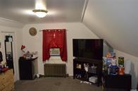 110 Powell Pl, Hempstead, NY 11550 - bedroom with radiator heating unit and lofted ceiling