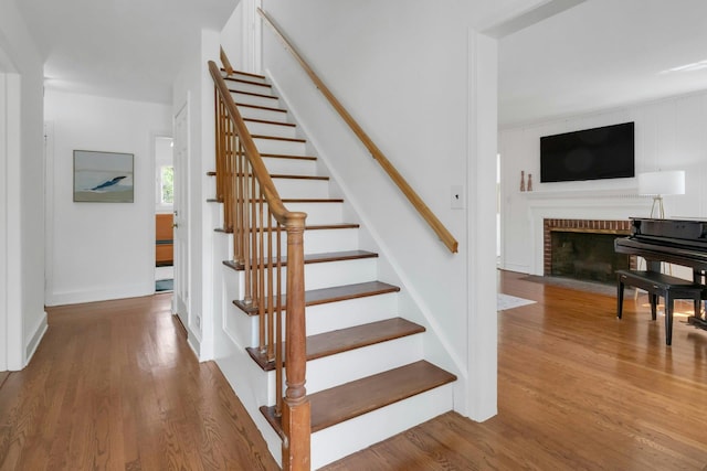40 Brookby Rd, Scarsdale, NY 10583 - stairway with wood finished floors, a fireplace, and baseboards