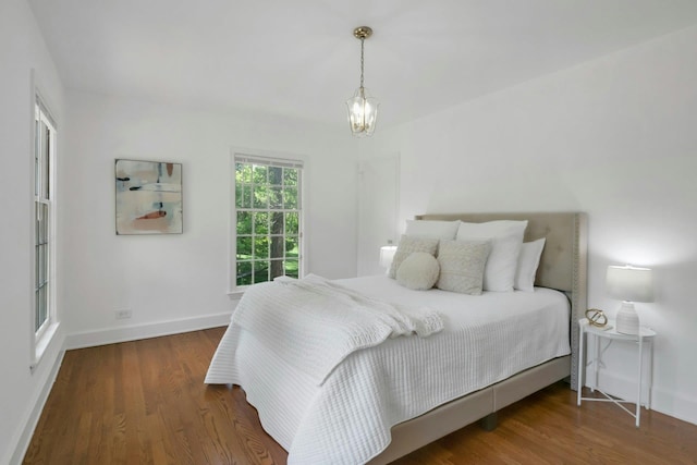 40 Brookby Rd, Scarsdale, NY 10583 - bedroom featuring baseboards, wood finished floors, and a chandelier