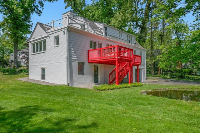 40 Brookby Rd, Scarsdale, NY 10583 - rear view of property featuring a wooden deck, a yard, driveway, stairway, and an attached garage