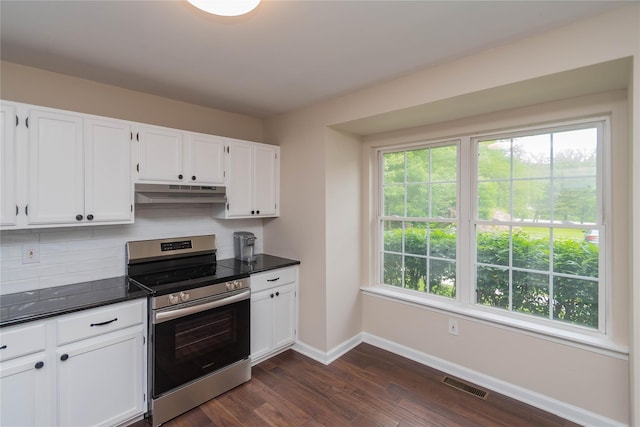 9 Clara Ct, Cortlandt Manor, NY 10567 - kitchen featuring stainless steel range with electric stovetop, under cabinet range hood, dark countertops, baseboards, and dark wood-style flooring