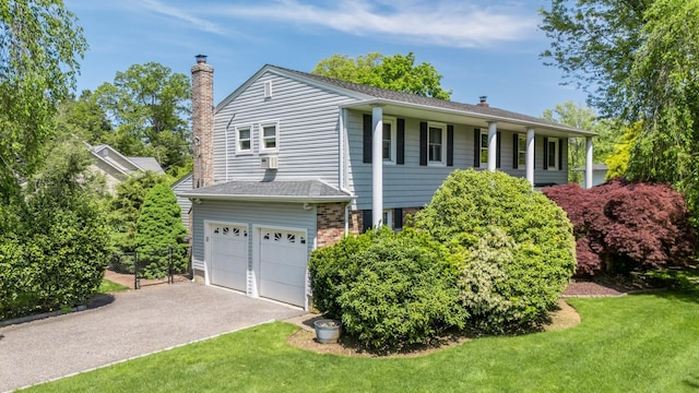 1 Karin Ct, East Northport, NY 11731 - view of front of home with an attached garage, a chimney, and asphalt driveway