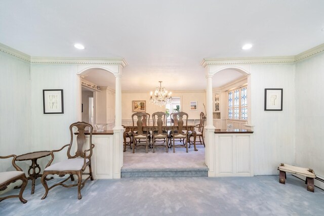 1 Karin Ct, East Northport, NY 11731 - carpeted dining area featuring decorative columns, crown molding, a chandelier, arched walkways, and a decorative wall