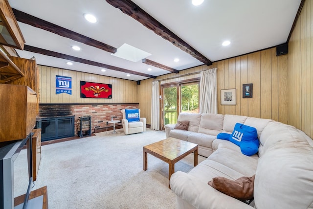 1 Karin Ct, East Northport, NY 11731 - carpeted living room featuring a skylight, beam ceiling, wooden walls, a fireplace, and recessed lighting
