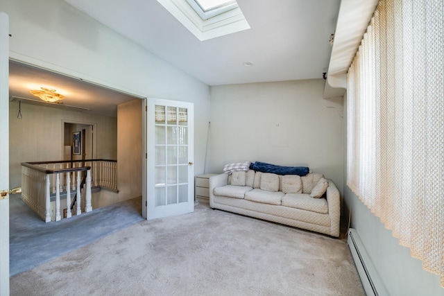 1 Karin Ct, East Northport, NY 11731 - living area with a baseboard radiator, carpet flooring, a skylight, and an upstairs landing