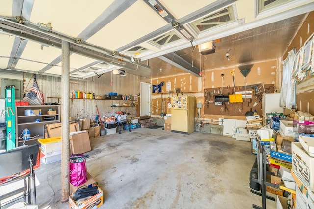1 Karin Ct, East Northport, NY 11731 - garage featuring freestanding refrigerator and a garage door opener