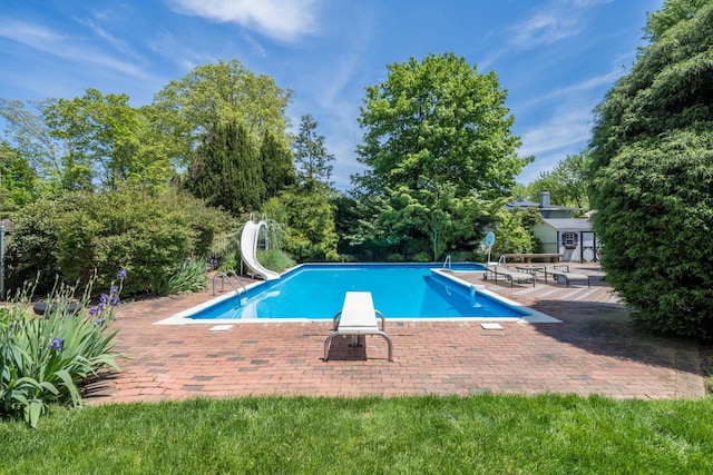 1 Karin Ct, East Northport, NY 11731 - outdoor pool with a water slide, a patio area, a diving board, and view of scattered trees