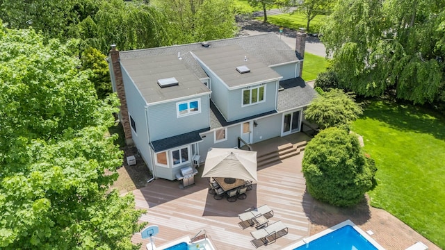 1 Karin Ct, East Northport, NY 11731 - rear view of property featuring a chimney, a wooden deck, and a lawn