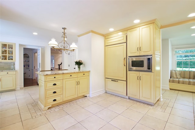 kitchen with stainless steel microwave, cream cabinetry, light tile patterned flooring, and recessed lighting