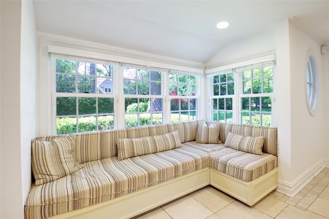 sunroom / solarium featuring healthy amount of natural light and vaulted ceiling