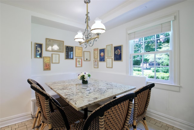 dining area with a chandelier, light tile patterned floors, and baseboards