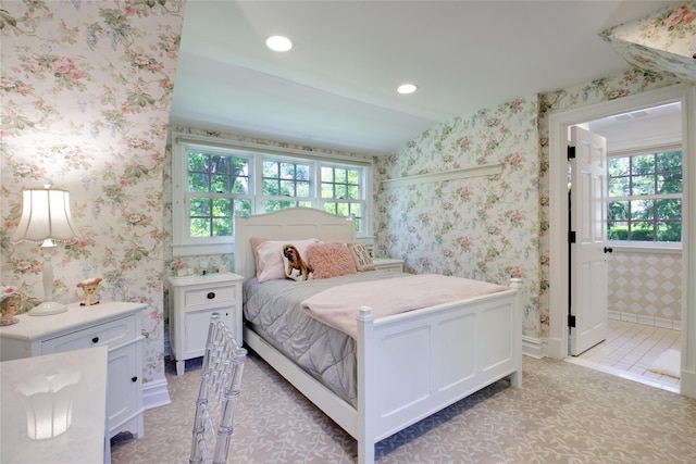 bedroom with connected bathroom and recessed lighting