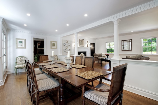 dining room with decorative columns, healthy amount of natural light, a fireplace, recessed lighting, and dark wood-style floors
