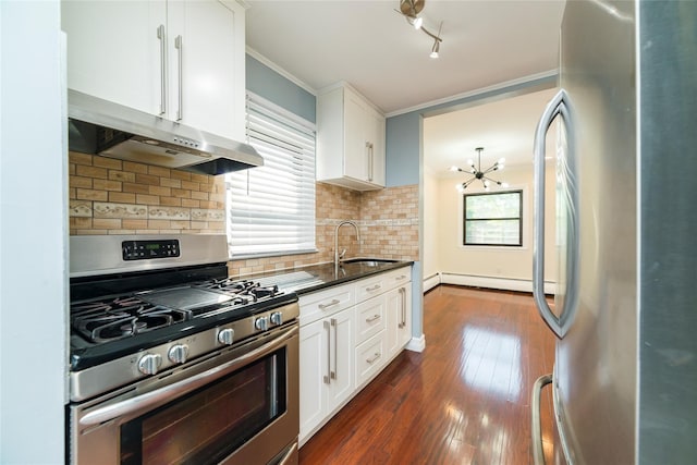kitchen with stainless steel appliances, under cabinet range hood, a sink, and white cabinetry