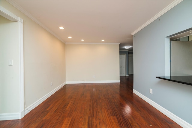 spare room with recessed lighting, baseboards, wood finished floors, and ornamental molding