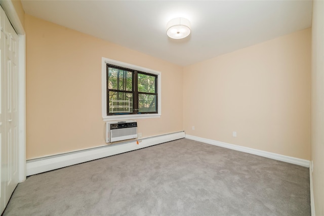 spare room featuring baseboard heating, carpet flooring, an AC wall unit, and baseboards