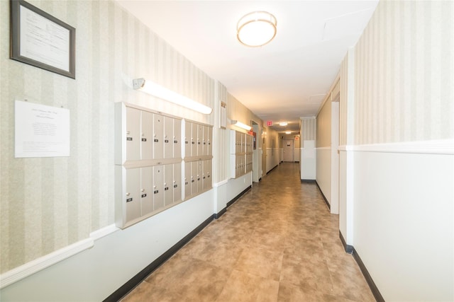 corridor featuring wallpapered walls and baseboards