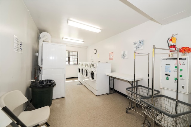 communal laundry room featuring light flooring and washing machine and dryer