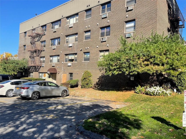 view of apartment building / complex featuring uncovered parking