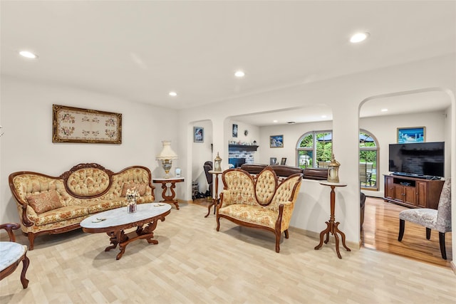 8 Wichard Blvd, Commack, NY 11725 - living room featuring recessed lighting, light wood-style flooring, arched walkways, and baseboards