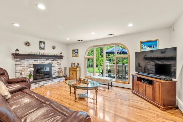 8 Wichard Blvd, Commack, NY 11725 - living area with light wood-style flooring, recessed lighting, and a brick fireplace