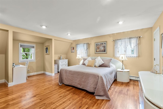 8 Wichard Blvd, Commack, NY 11725 - bedroom featuring light wood-style flooring, a baseboard heating unit, baseboards, and lofted ceiling