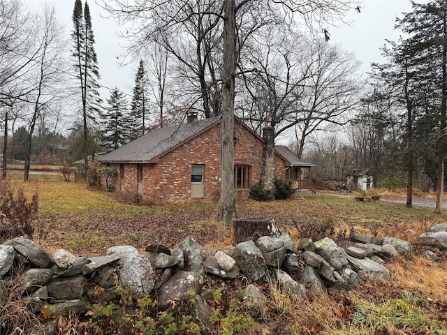 47 River Ln, Bloomingburg, NY 12721 - view of side of property with a chimney and brick siding