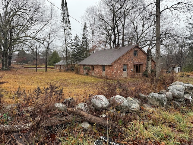 47 River Ln, Bloomingburg, NY 12721 - view of side of property with a chimney and brick siding