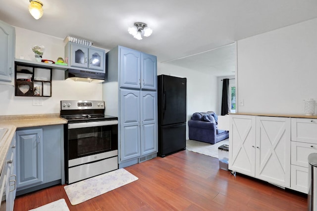 10 Van Wyck Dr, Poughkeepsie, NY 12601 - kitchen with electric range, freestanding refrigerator, under cabinet range hood, light countertops, and dark wood-type flooring