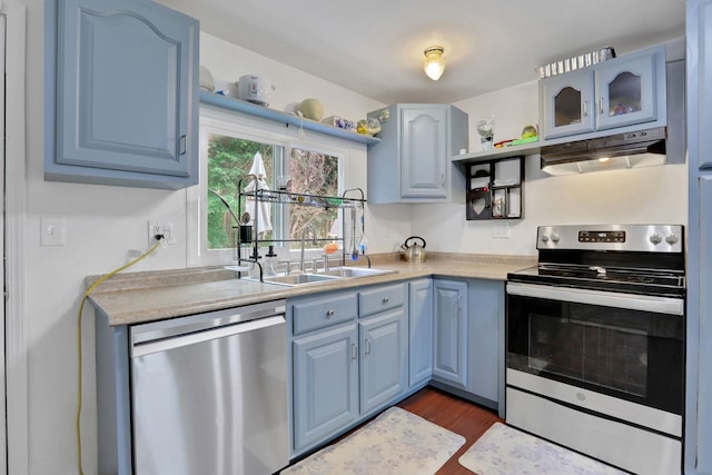 10 Van Wyck Dr, Poughkeepsie, NY 12601 - kitchen with stainless steel appliances, a sink, under cabinet range hood, blue cabinetry, and light countertops