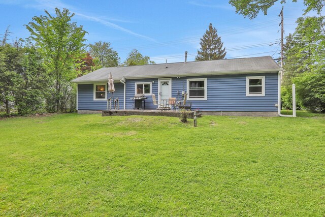 10 Van Wyck Dr, Poughkeepsie, NY 12601 - back of property with a lawn and a patio