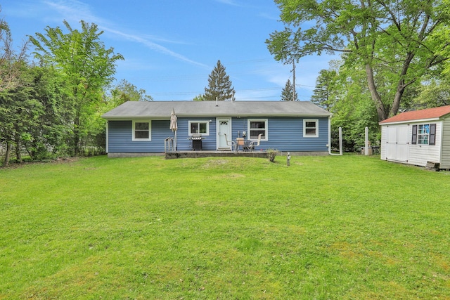10 Van Wyck Dr, Poughkeepsie, NY 12601 - rear view of property with a lawn, an outbuilding, a storage unit, and a patio