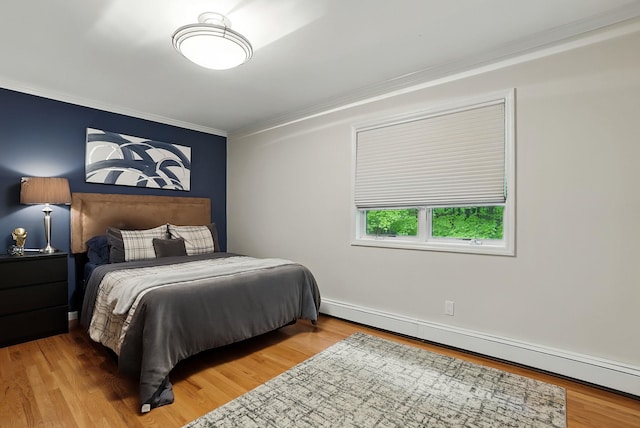 12 Rockridge Rd, Ardsley, NY 10502 - bedroom featuring baseboard heating, crown molding, wood finished floors, and baseboards