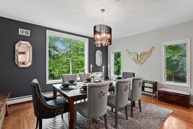12 Rockridge Rd, Ardsley, NY 10502 - dining area with a chandelier, a baseboard radiator, wood finished floors, and crown molding