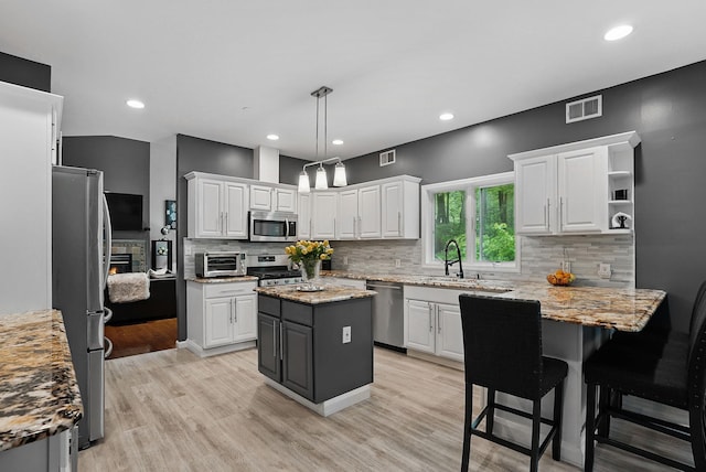 12 Rockridge Rd, Ardsley, NY 10502 - kitchen with appliances with stainless steel finishes, a sink, white cabinets, tasteful backsplash, and recessed lighting