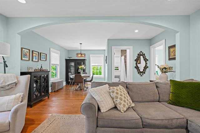 14 Mercer St, Middletown, NY 10940 - living room with arched walkways, radiator, light wood finished floors, and recessed lighting