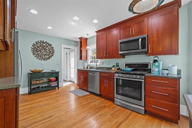 14 Mercer St, Middletown, NY 10940 - kitchen with stainless steel appliances, light wood-type flooring, recessed lighting, dark stone countertops, and a sink