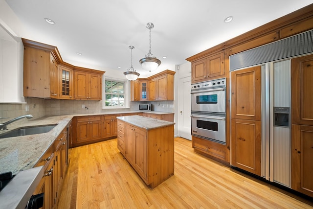 681 W 231st St, Bronx, NY 10463 - kitchen with a sink, stainless steel appliances, tasteful backsplash, light wood-style floors, and recessed lighting