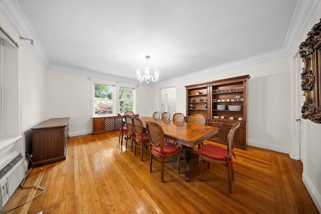 681 W 231st St, Bronx, NY 10463 - dining area with a chandelier, light wood-style floors, crown molding, and baseboards