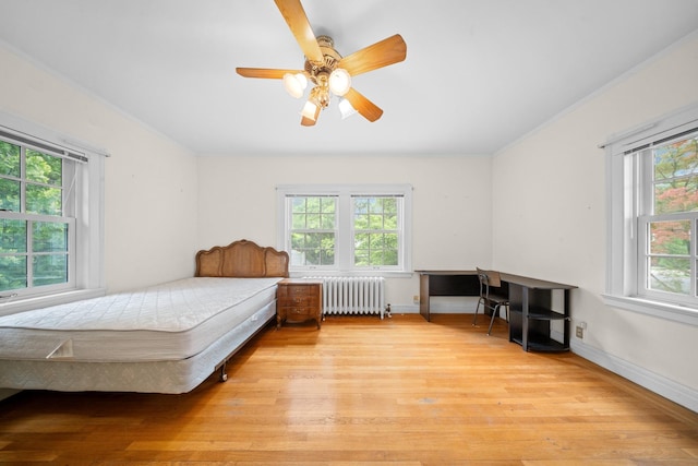 681 W 231st St, Bronx, NY 10463 - bedroom featuring radiator heating unit, wood finished floors, baseboards, and ceiling fan