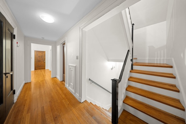 681 W 231st St, Bronx, NY 10463 - hallway featuring light wood-style flooring, baseboards, and stairway
