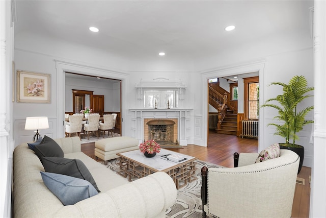 30 Huntting Ln, East Hampton, NY 11937 - living area featuring wood finished floors, recessed lighting, stairs, a decorative wall, and a fireplace with flush hearth