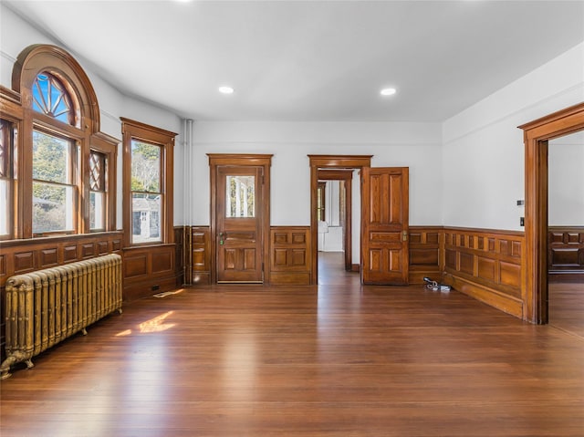 30 Huntting Ln, East Hampton, NY 11937 - unfurnished room with radiator heating unit, a wainscoted wall, wood finished floors, and recessed lighting