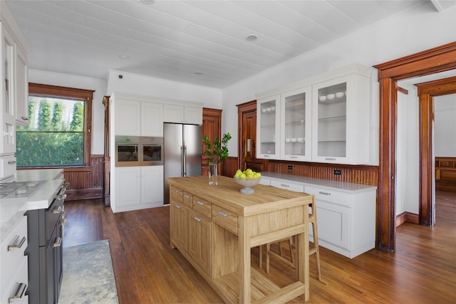 30 Huntting Ln, East Hampton, NY 11937 - kitchen with stainless steel appliances, dark wood-style flooring, white cabinets, glass insert cabinets, and wood counters