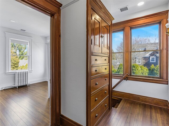 30 Huntting Ln, East Hampton, NY 11937 - corridor featuring radiator, dark wood-type flooring, and baseboards