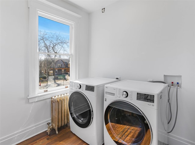 30 Huntting Ln, East Hampton, NY 11937 - washroom featuring radiator, separate washer and dryer, wood finished floors, and baseboards